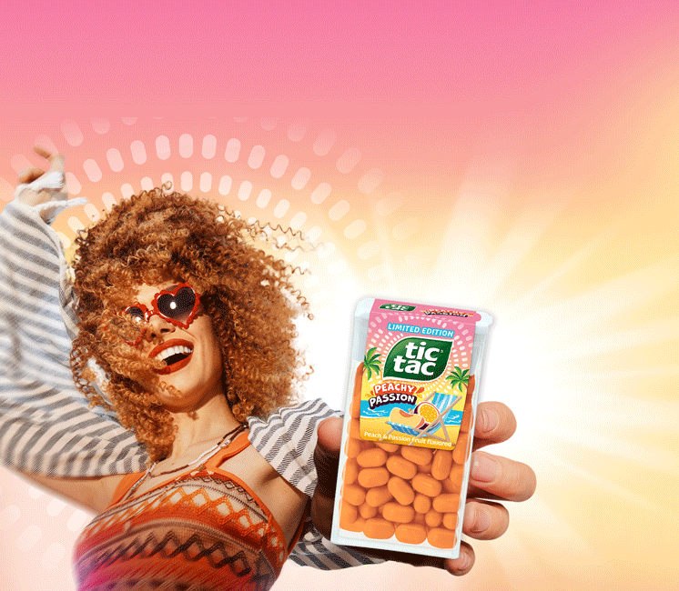 Woman holding Tic Tac® Peachy Passion pack.